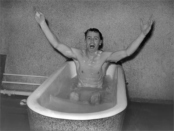 Villa captain Johnny Dixon celebrates in the Wembley baths after the 1957 FA Cup Final