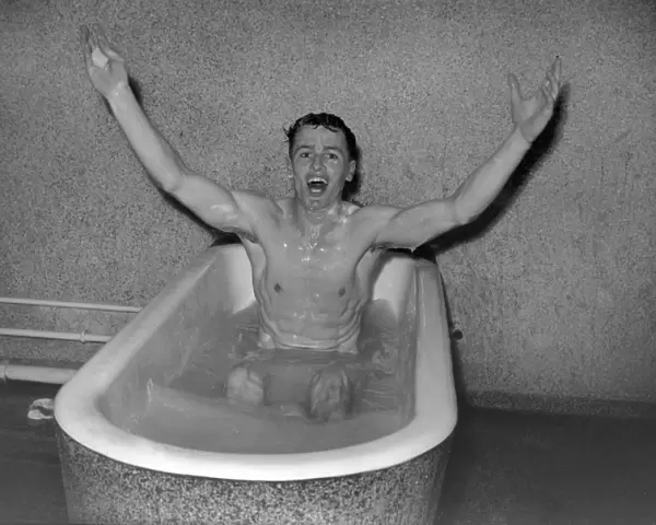 Villa captain Johnny Dixon celebrates in the Wembley baths after the 1957 FA Cup Final