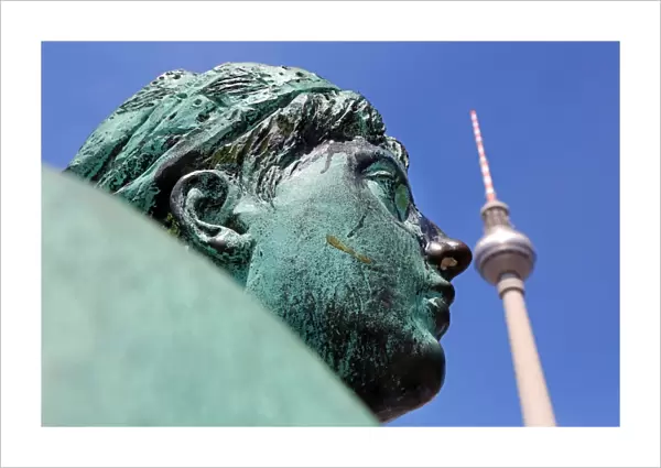 Berlin TV Tower, Fernsehturm, television tower and a statue on the Neptune fountain in Berlin, Germany