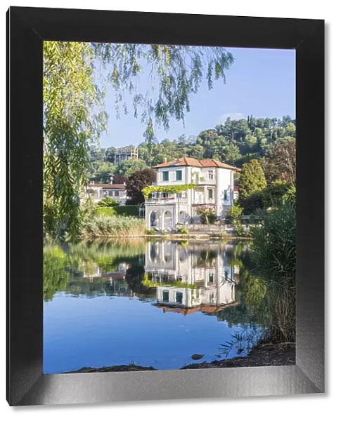 House reflected in the Pusiano lake, Como Province, Lombardy, Italy