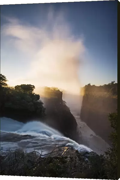 The Victoria Falls depicted at sunrise from Devils Cataract, in Zimbabwe side