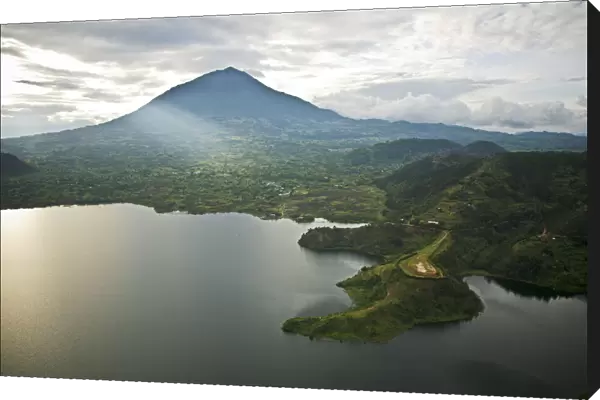 Rwanda. Lake Burero reaches out underneath the volcanoes