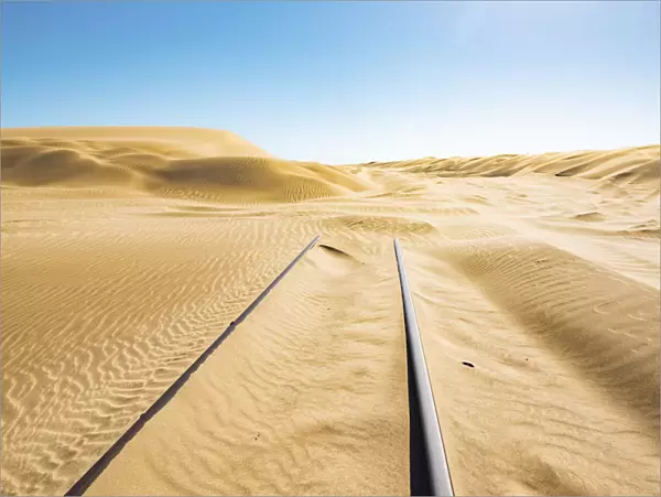 Railway tracks leading into a sand dune, Luderitz, Namibia, Africa