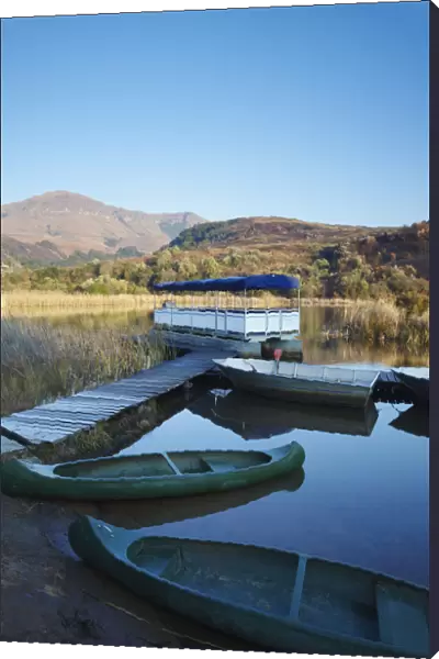 Canoes on lake with Drakensberg mountains in background, Ukhahlamba-Drakensberg Park
