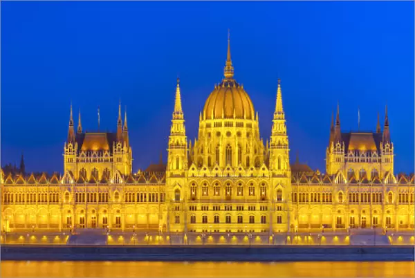 Hungarian Parliament Building & The River Danube illuminated at dusk, Budapest, Hungary