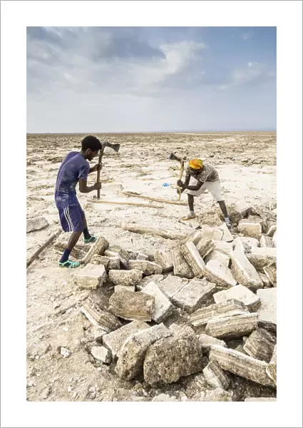 Two miners breaking up salt blocks in the salt flat, Danakil Depression, Afar Region