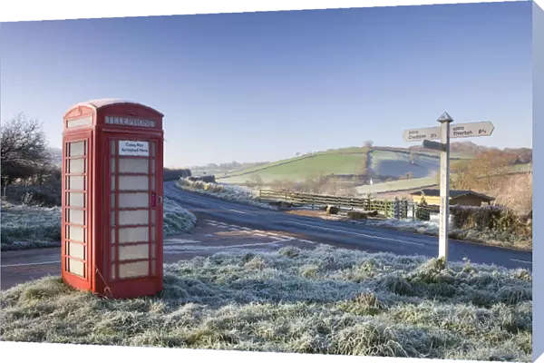 Traditional English telephone box in the frost at Stockleigh Pomeroy, Devon, England