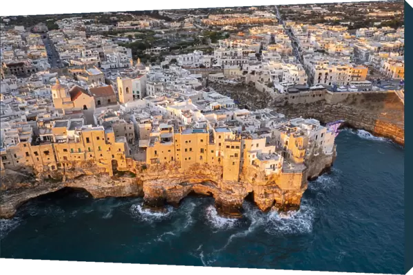 Overhanging houses of Polignano a Mare at sunrise. Bari district, Apulia, Italy