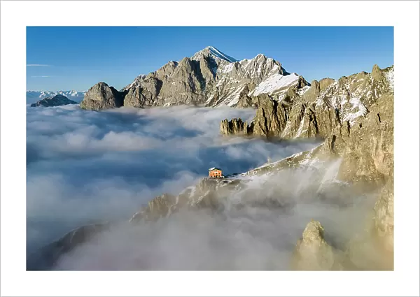 Rifugio rosalba emerge from the clouds. Grignetta, Grigne group, Lake Como, Italy