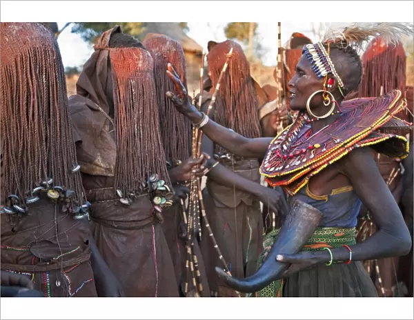 At the start of a Ngetunogh ceremony, the mothers of Pokot initiates will smear animal fat on the boys masks as a blessing. The boys must wear goatskins, conceal their faces with masks made from wild sisal (sansevieria) and carry bows with