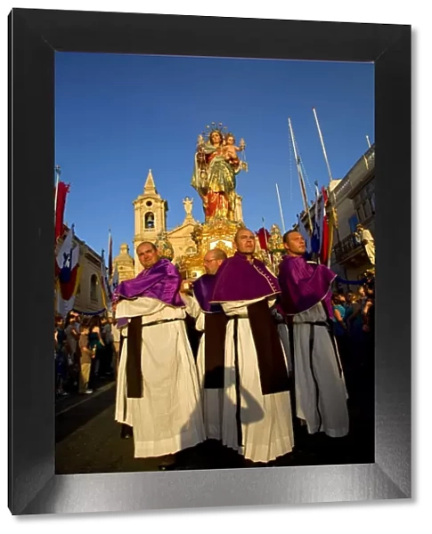 Malta, Zurrieq; Men carrying the statue of the Madonna, the patron saint during the annual parade