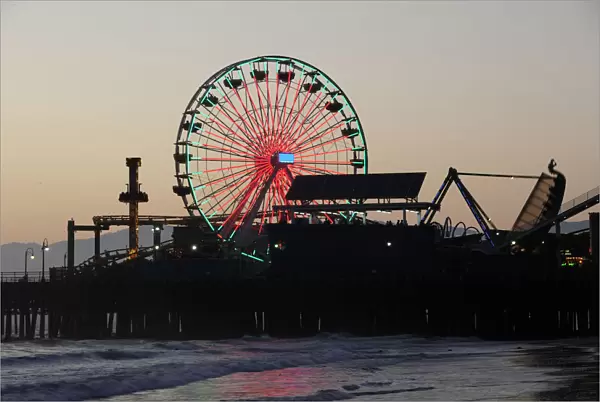 Santa Monica pier Silhouetted at dusk. Ferris wheel funfair