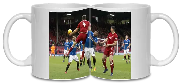 Rangers Alfredo Morelos Soars for the Ball in Intense Rangers vs Aberdeen Clash at Pittodrie Stadium