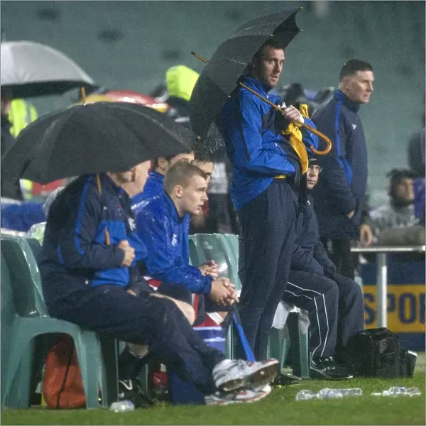 Rangers FC's Alan McGregor Shields the Bench with an Umbrella during Sydney Festival of Football 2010