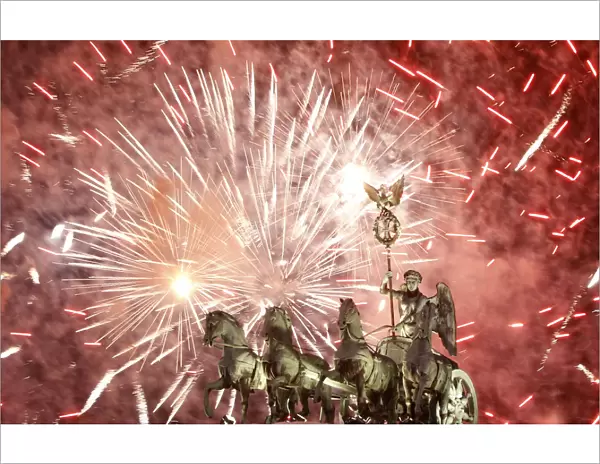 Fireworks illuminate Quadriga sculpture atop Brandenburg Gate in Berlin