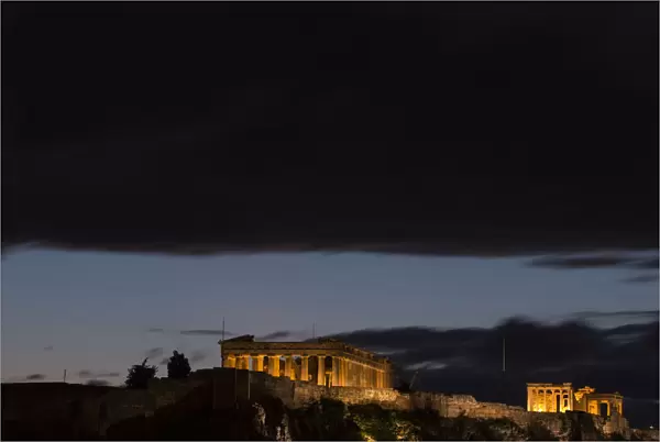 Dark clouds gather above the Parthenon Temple at the archaeological site of the Acropolis