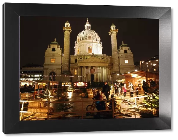 Karlskirche church is pictured behind an advent market in Vienna