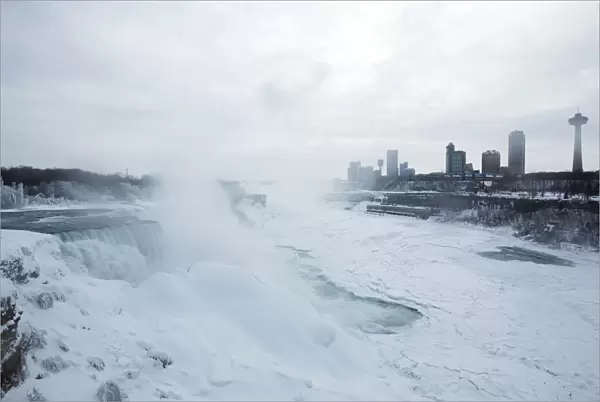 A snow-covered landscape is seen over the frozen Niagara Falls in Niagara Falls, New York
