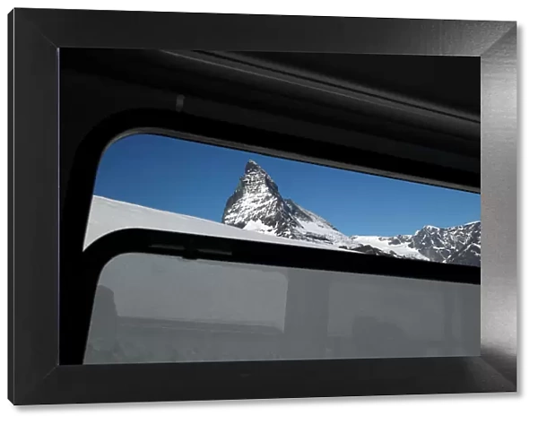 The Matterhorn mountain is pictured through a train window in Zermatt