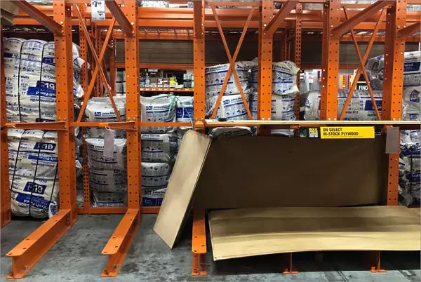 Partially empty shelves for plywood are seen at a Home Depot store ahead of the arrival