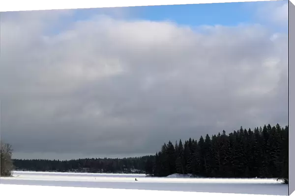 Man is seen fishing on a frozen lake at the Pajulahti sports center near Lahti