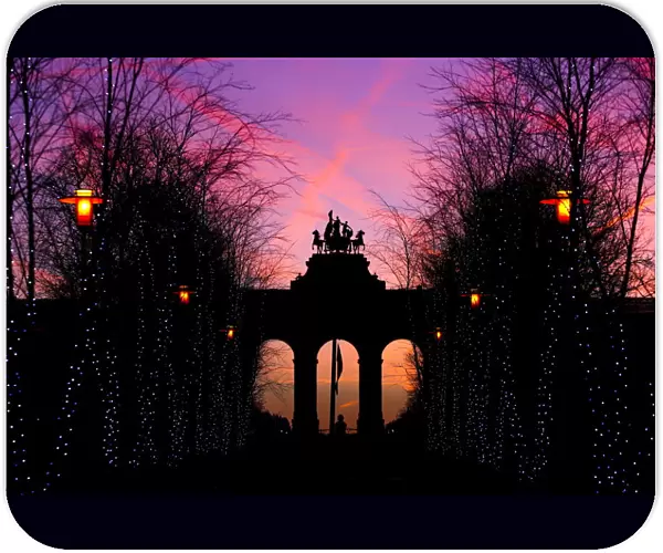 The sun rises behind the Cinquantenaire arch in Brussels