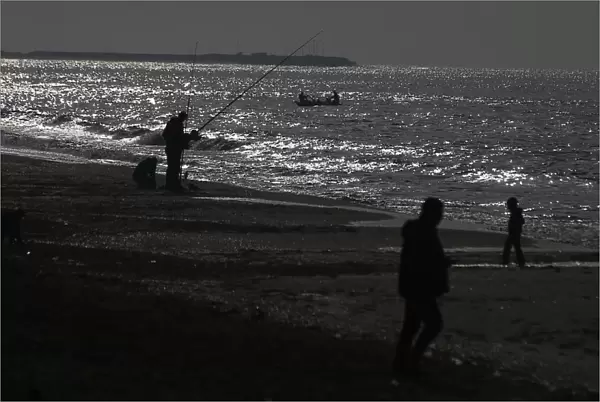 Palestinians fish at the sea near Rafah in the southern Gaza Strip