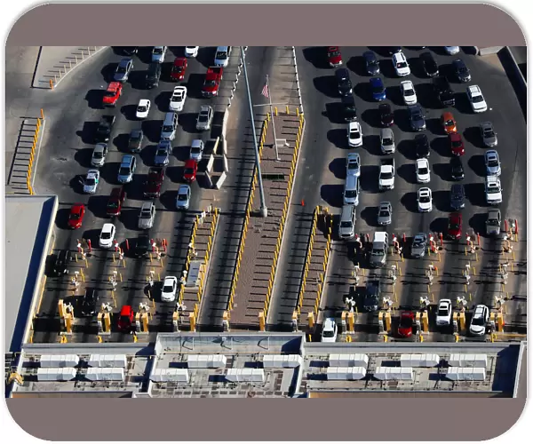 Automobiles pass through the U. S. border and into the United States from Juarez