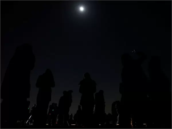 People wait to watch a lunar eclipse at the open air skydeck of Roppongi Hills Tower in