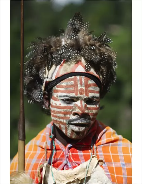 Kikuyu warrior wearing headress made of Helmeted Guineafowl feathers Tomson Falls Kenya
