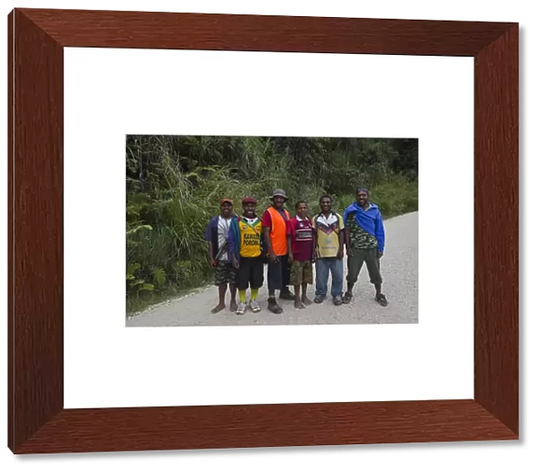 Young men posing for picture on Highlands Highway in Southern Highlands Papua New Guinea