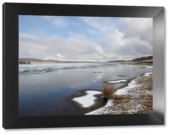 View of frozen freshwater loch with patches of snow, Lochindorb, Strathspey, Morayshire, Highlands, Scotland, March