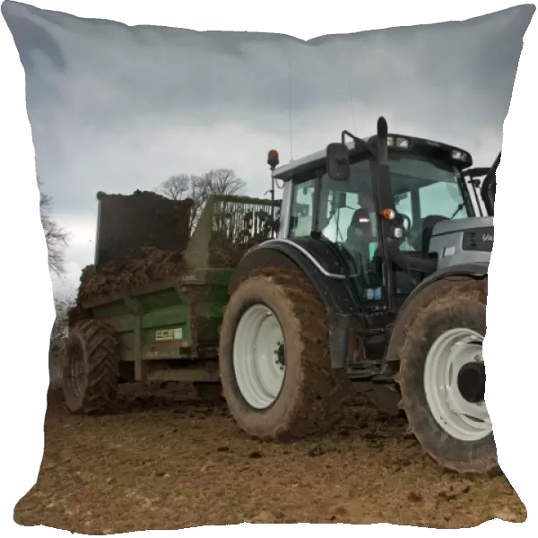 Valtra T151 tractor with muck spreader, spreading muck on arable field, England, march