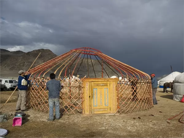 Kazakh nomads erecting ger camp, in preparation for Eagle Hunters Festival, Altai Mountains, Bayan-Ulgii