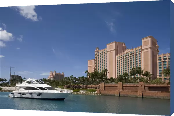 Bahamas, Paradise Island, Yacht motors into marina at Atlantis Resort