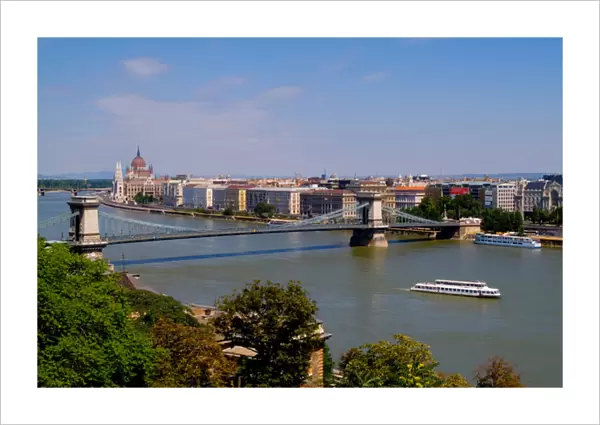 Cruise river boat taken from hill overlooking Chain Bridge Danube River and Parliament