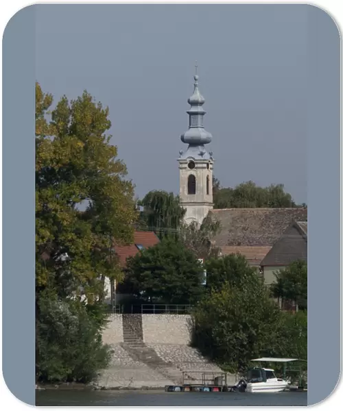 Hungary. Danube River view near Kalocsa. Typical waterfront village with clock tower