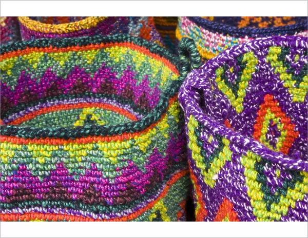 Central America, Guatemala, Chichicastenango. Colorful woven baskets in the market