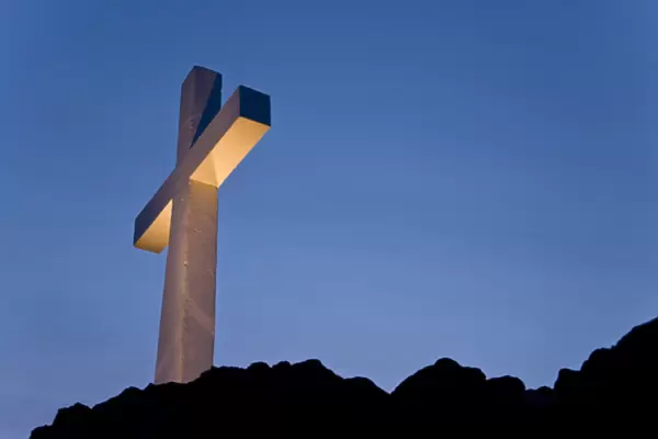 USA, Idaho, Caldwell. Lizard Butte cross is lit for a special event