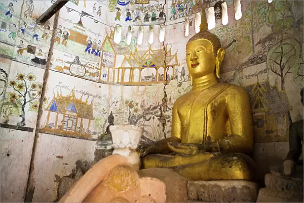 A buddha sits in an ancient buddhist temples in Xe Champhone, Laos