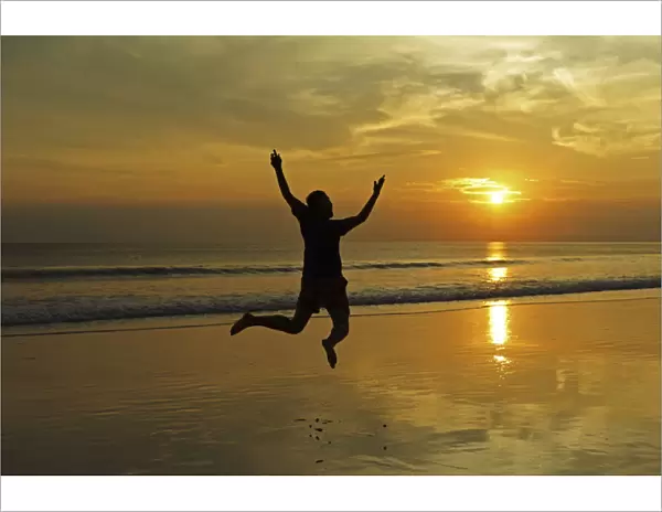 India, Andaman Islands, Havelock, beach number 7, shadow of man jumping at sunset