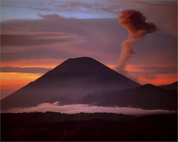 Indonesia. Mt. Semeru emits a plume of smoke moved by strong winds at sunrise. Credit as