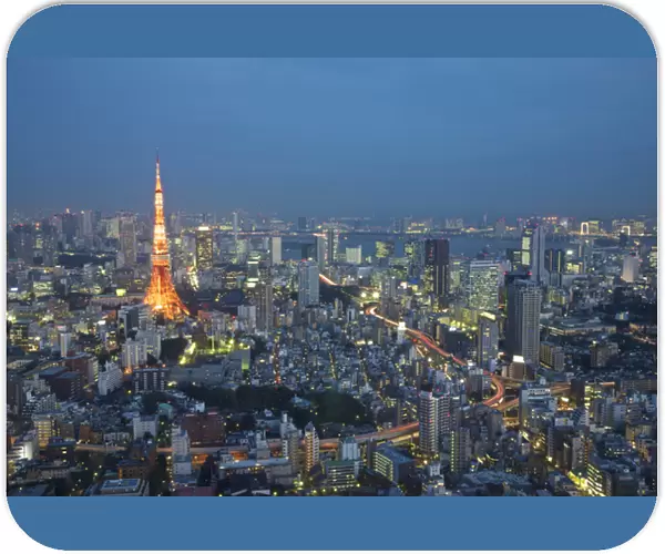 Japan, Tokyo. Sunset aerial of downtown including Tokyo Tower and Rainbow Bridge