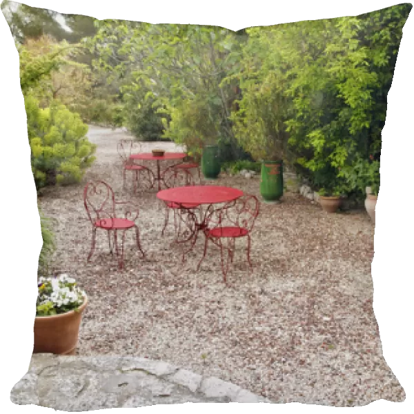 Red tables and chairs in outdoor sitting area, Provence region of southern France
