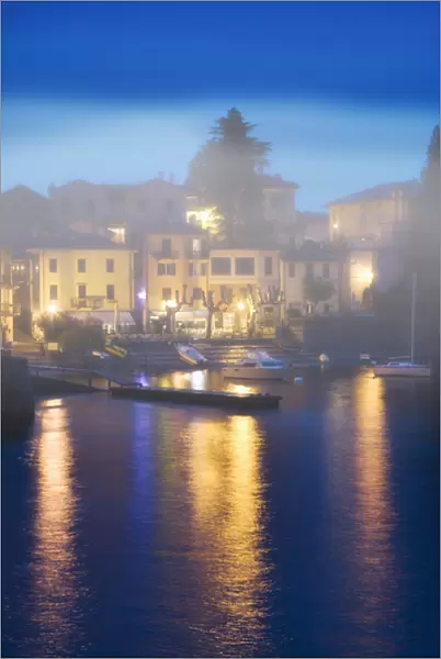 Europe, Italy, Varenna. Misty evening dock scene on the shores of Lake Como. Credit as