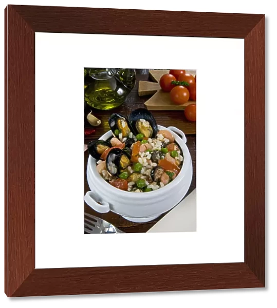 Seafood rice with mussels, shrimps, tomato, olives, peas, Italian cuisine, Italian food