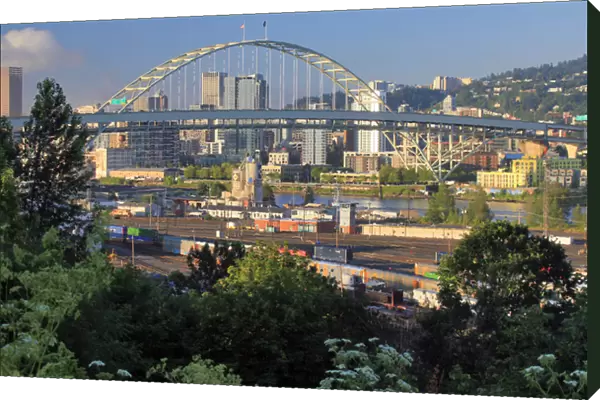 USA, Oregon, Portland. Fremont Bridge over Willamette River and railroad yard. Credit as