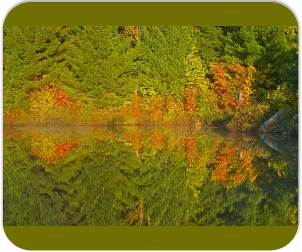 Canada, Ontario, Sudbury. Autumn colors reflect in Lake Laurentian at sunrise