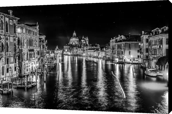 Black and white Grand Canal and Santa Maria della Salute church at night with reflection