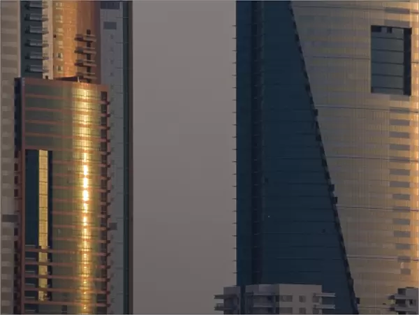 UAE, Dubai, Media City. Reflections on glass of Al Salam Tecom Tower in Media City